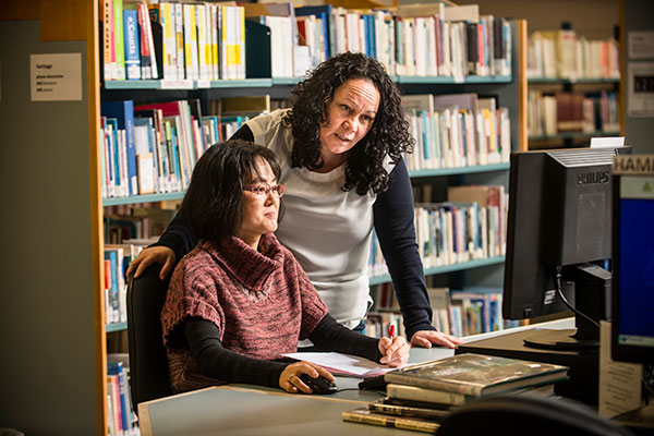 Two people working at computer