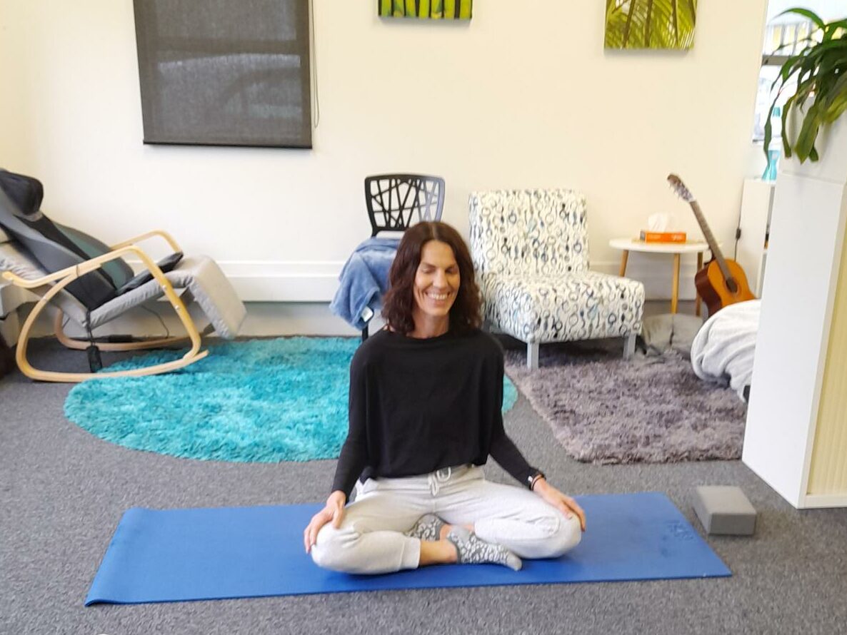 Yoga instructor on mat.