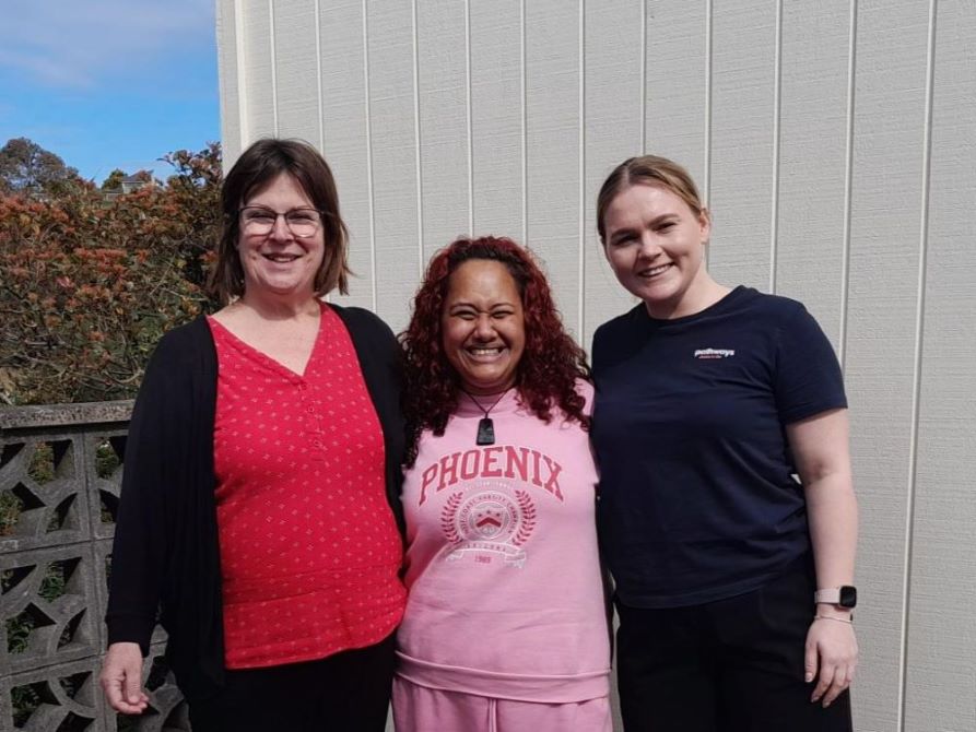 A beaming Shannon stands with her Pathways support workers.