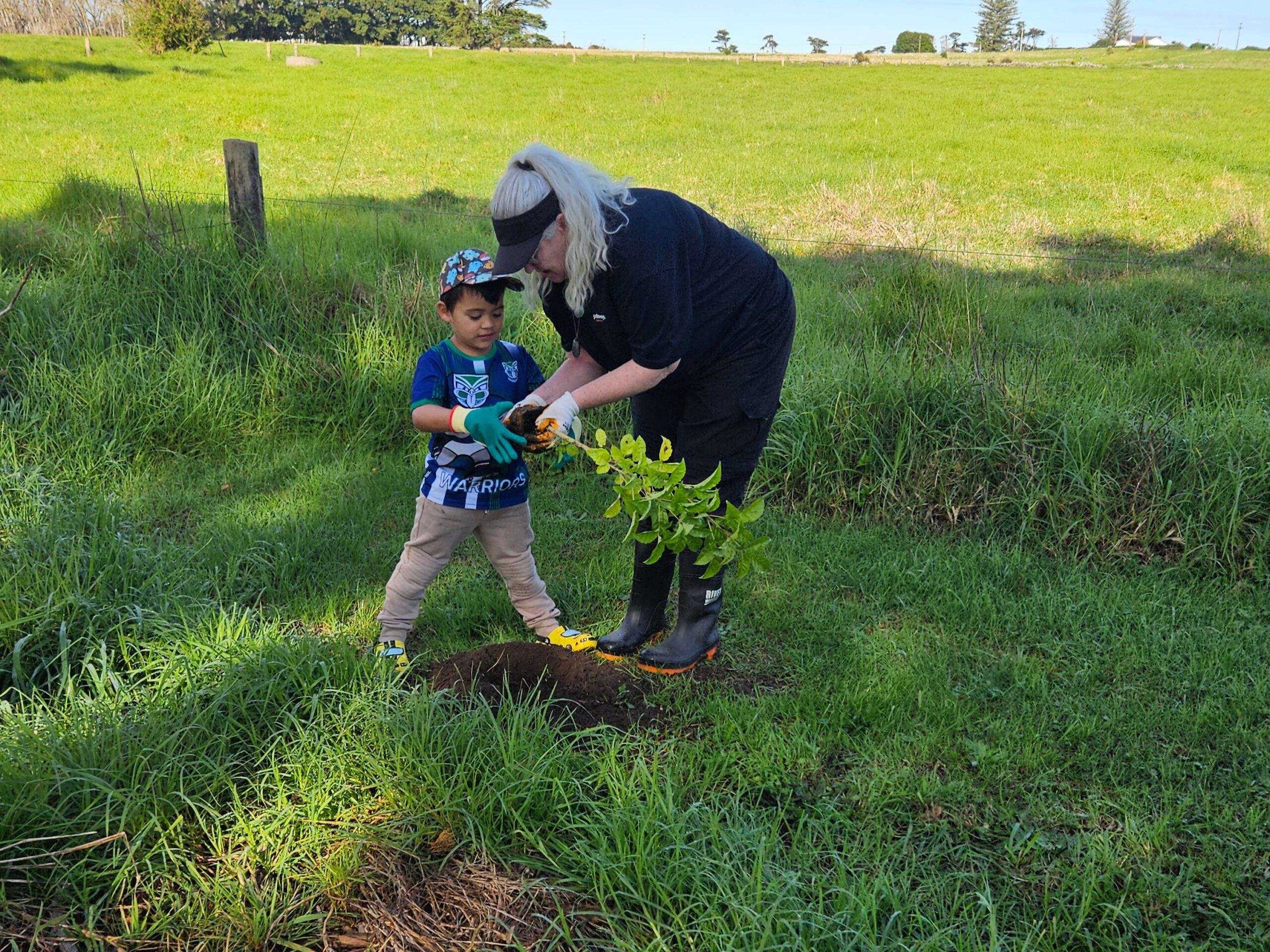 Grandma helping her grandson planting