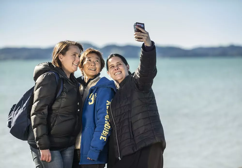 Three people taking a selfie at the beach