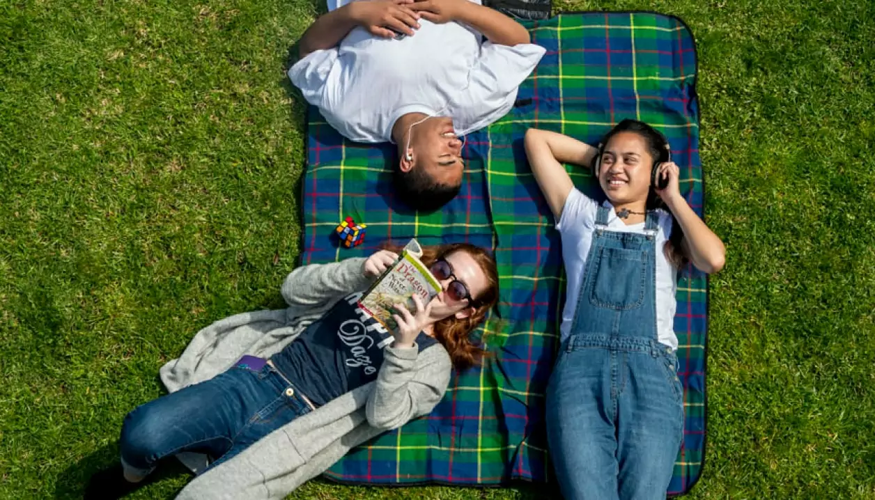 Young people lying down on a blanket