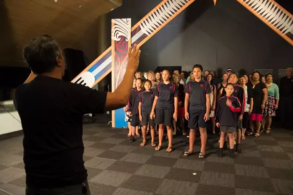 Group of people singing Pathways' waiata