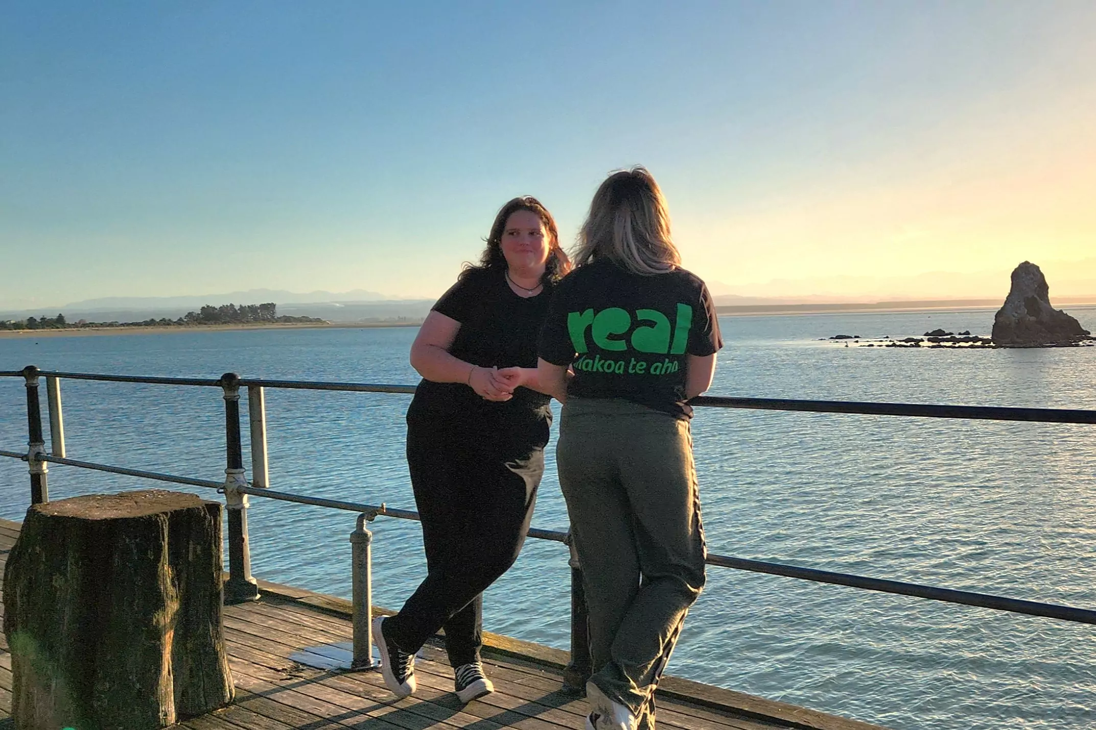 Two people standing on the waterfront, Nelson